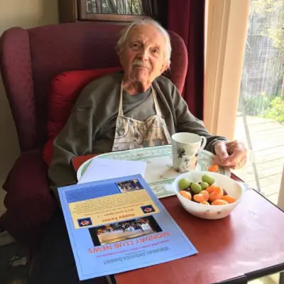 Man with tea and newsletter